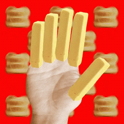 A Hand Holding A Stack Of Butter Sticks GIF