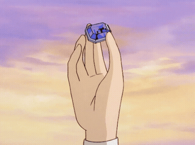 A Hand Is Holding A Blue Box With A Cross On It In Front Of A Cloudy Sky GIF