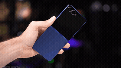 A Hand Is Holding A Blue Cell Phone With A Black Back GIF