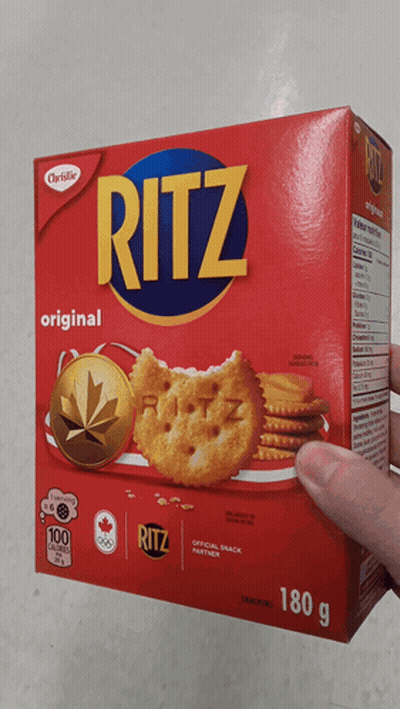 A Hand Is Holding A Box Of Ritz Original Crackers GIF