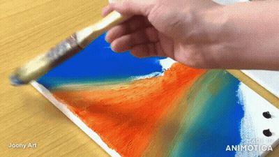 A Hand Is Holding A Brush Over A Piece Of Paper That Says ' Made In Animatica ' On It GIF