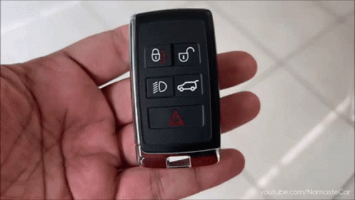 A Hand Is Holding A Car Key That Has The Letters E And D On The Buttons GIF