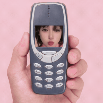 A Hand Is Holding A Cell Phone With A Picture Of A Girl On The Screen GIF
