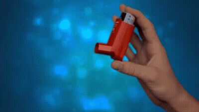 A Hand Is Holding A Red Inhaler With The Number 4 On It GIF
