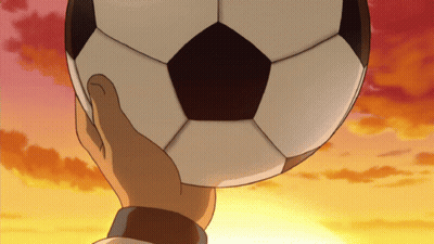 A Hand Is Holding A Soccer Ball In Front Of A Sunset Sky GIF