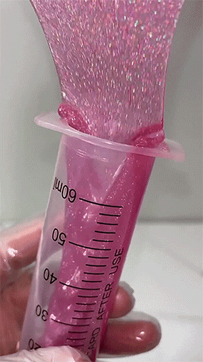 A Hand Is Holding A Syringe That Says 60Ml GIF