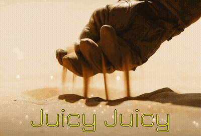 A Hand Is Holding Sand And The Words Juicy Juicy Are Written Below It GIF