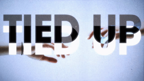 A Hand Is Holding The Word Tied Up In Black And White GIF