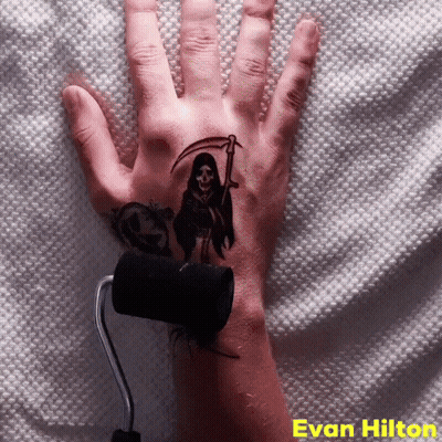 A Hand With A Grim Reaper Tattoo On It GIF