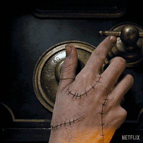 A Hand With Stitches On It Is Opening A Safe With A Netflix Logo In The Background GIF