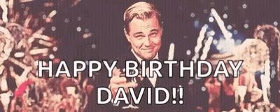 A Happy Birthday David Sign With A Man In A Tuxedo Holding A Toast GIF