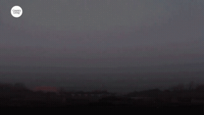 A Harvest Moon Is Shown In A Dark Sky GIF