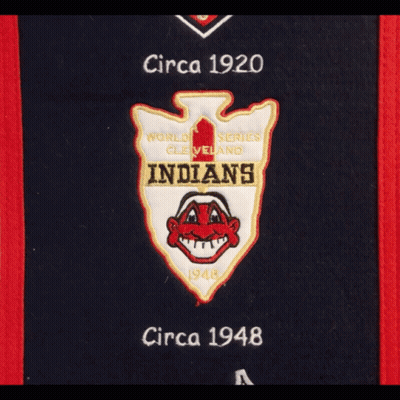 A Hat Hanging On A Door With A Cleveland Indians Banner GIF