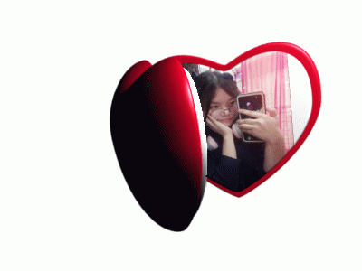 A Heart Shaped Mirror Shows A Woman Taking A Selfie GIF