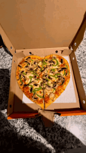 A Heart Shaped Pizza With Mushrooms Peppers And Cheese GIF