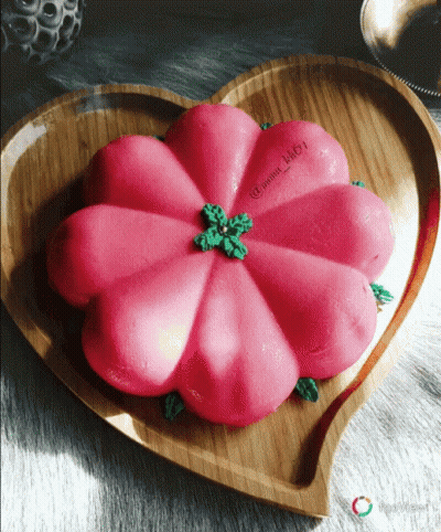 A Heart Shaped Plate With A Pink Flower On Top GIF