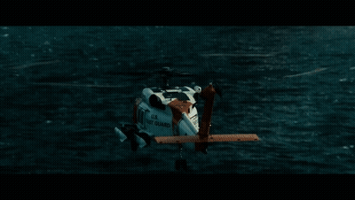 A Helicopter From The U.s. Navy Is Flying Over A Body Of Water GIF