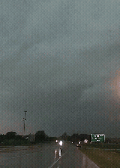 A Highway With A Green Sign That Says La Quinta GIF
