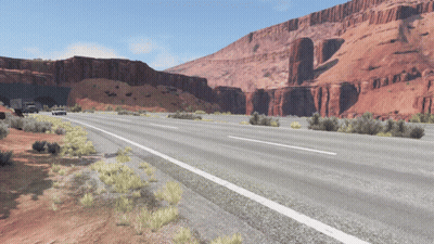 A Highway With A Tunnel In The Background And Mountains In The Background GIF