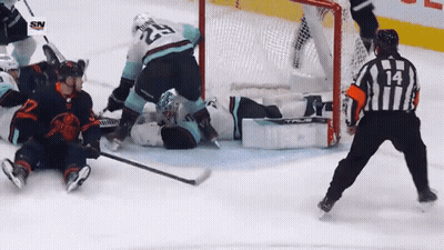 A Hockey Game Is Being Played And The Referee Has The Number 14 On His Jersey GIF
