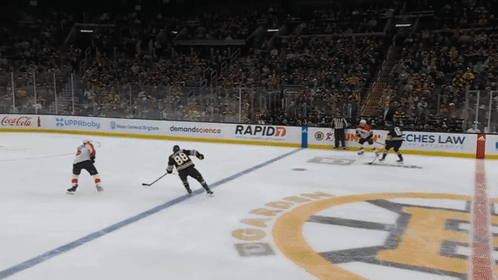 A Hockey Game Is Being Played In A Stadium Sponsored By Rapid7 GIF