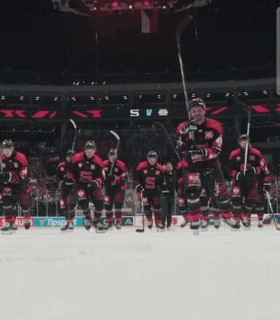 A Hockey Game Is Being Played In A Stadium With A Banner For Sauss GIF