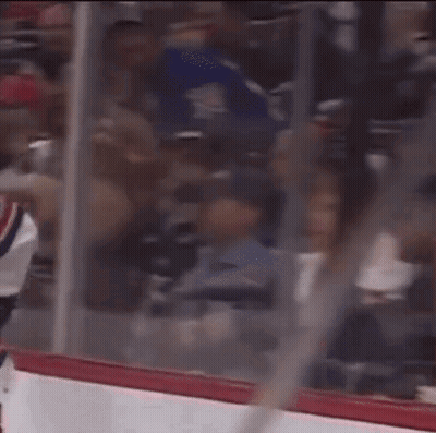 A Hockey Game Is Being Played In A Stadium With A Lot Of People In The Stands GIF