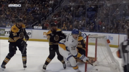 A Hockey Game Is Being Played In A Stadium With A Msg Logo On The Ice GIF