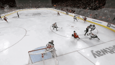 A Hockey Game Is Being Played In A Stadium With A Ticketmaster Advertisement On The Wall GIF