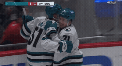A Hockey Game Is Being Played In California And The Players Are Hugging Each Other GIF