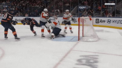 A Hockey Game Is Being Played In Front Of A Banner For Hyundai GIF