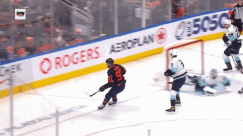 A Hockey Game Is Being Played In Front Of A Banner For Rogers Aeroplan GIF