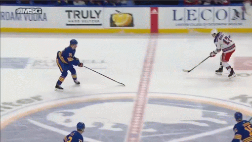 A Hockey Game Is Being Played In Front Of A Banner For Truly Vodka GIF
