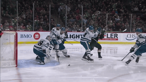 A Hockey Game Is Being Played In Front Of A Banner That Says Chs GIF