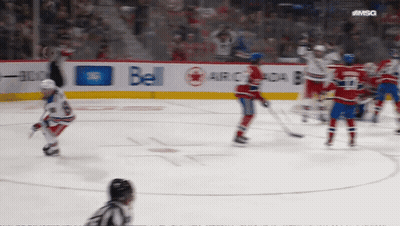 A Hockey Game Is Being Played In Front Of A Bell Ad GIF