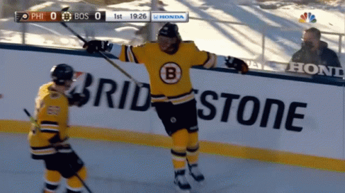 A Hockey Game Is Being Played In Front Of A Bridgestone Sign GIF