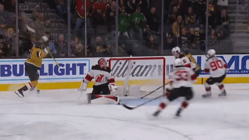 A Hockey Game Is Being Played In Front Of A Bud Light Banner GIF