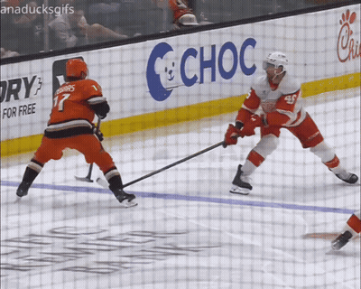 A Hockey Game Is Being Played In Front Of A Choc Sign GIF