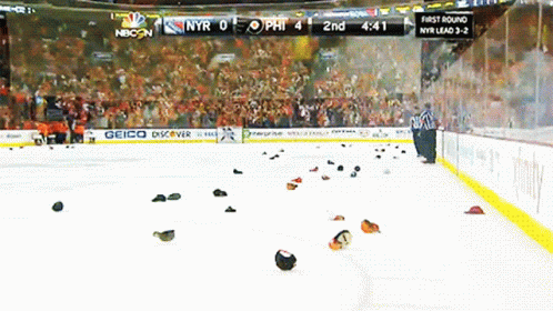 A Hockey Game Is Being Played In Front Of A Crowd And A Sign That Says Geico GIF