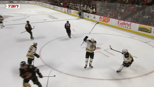 A Hockey Game Is Being Played In Front Of A Gabriel Pizza Sign GIF