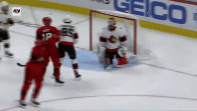 A Hockey Game Is Being Played In Front Of A Geico Advertisement GIF