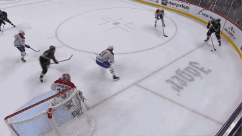 A Hockey Game Is Being Played In Front Of A Loffler Ad GIF