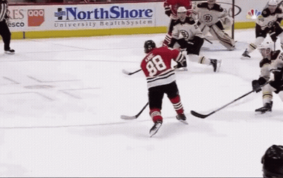 A Hockey Game Is Being Played In Front Of A Northshore University Health System Sign GIF