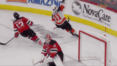 A Hockey Game Is Being Played In Front Of A Novacare Banner GIF