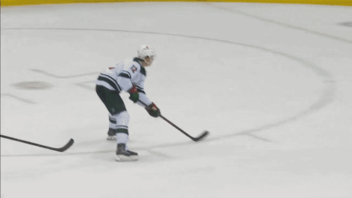 A Hockey Game Is Being Played In Front Of A Rwj Bank Sign GIF