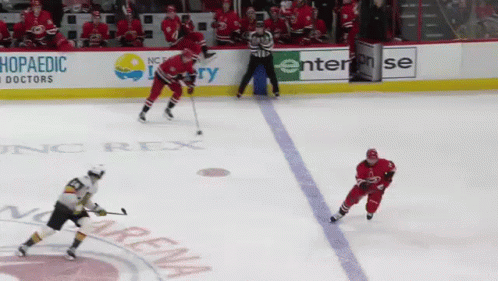 A Hockey Game Is Being Played In Front Of A Sign That Says Enterprise GIF
