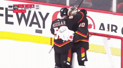 A Hockey Game Is Being Played In Front Of A Sign That Says Eway GIF