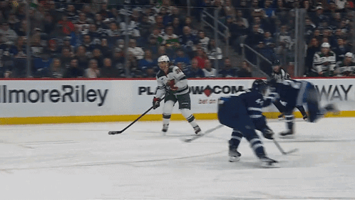 A Hockey Game Is Being Played In Front Of A Sign That Says Imore Riley GIF