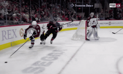 A Hockey Game Is Being Played In Front Of A Sign That Says Rex On It GIF