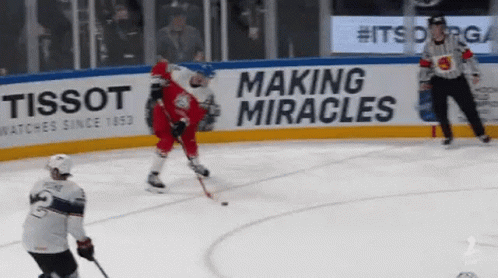 A Hockey Game Is Being Played In Front Of A Tissot Sign GIF